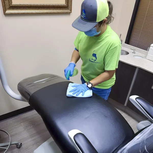 Cleaning staff member using eco-friendly products in a medical facility